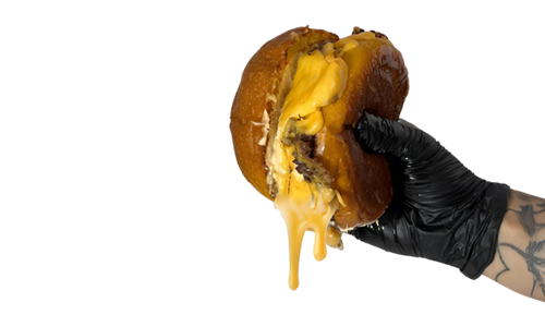 Hamburguesa con mucho queso derretido Mano cogiendo una hamburguesa